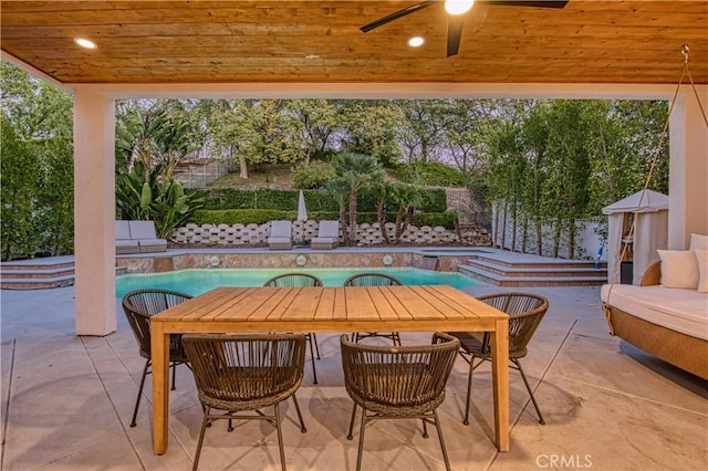 view of patio / terrace with a fenced backyard, an outdoor pool, and outdoor dining space