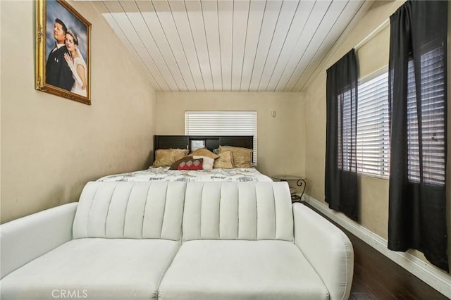 bedroom featuring wood finished floors, wood ceiling, and baseboards