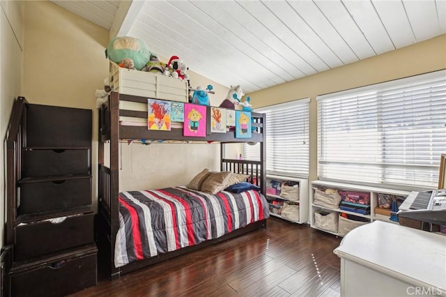 bedroom featuring dark wood-type flooring, wooden ceiling, and vaulted ceiling