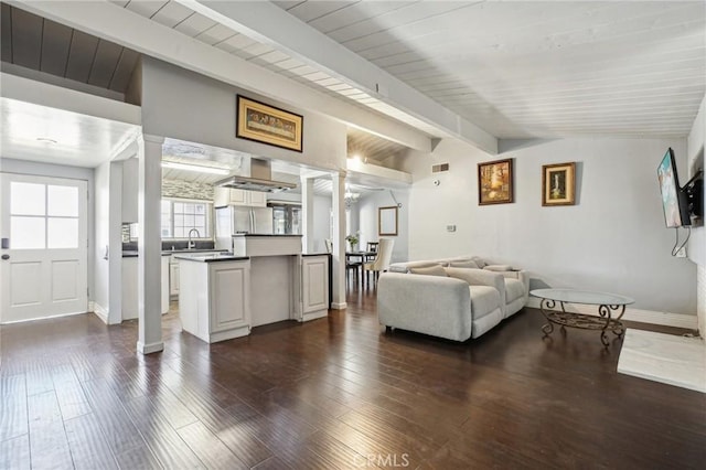 living room with lofted ceiling with beams, dark wood-style flooring, wood ceiling, baseboards, and ornate columns