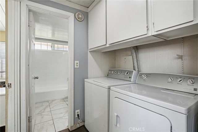 washroom featuring marble finish floor, cabinet space, and washing machine and clothes dryer