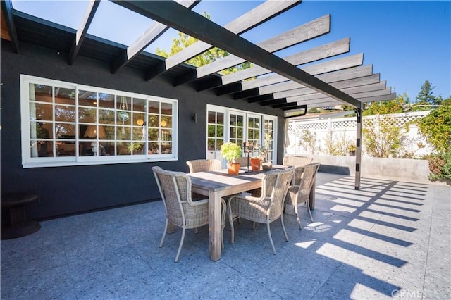 view of patio / terrace featuring fence, a pergola, and outdoor dining space