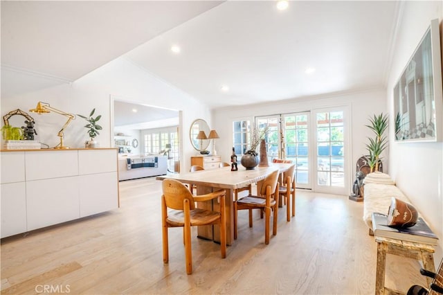 dining room with lofted ceiling, ornamental molding, light wood-type flooring, and recessed lighting