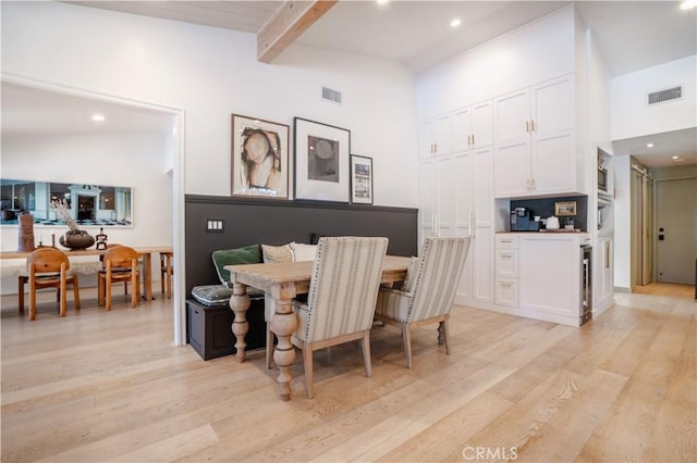 5910 Pat Ave, Woodland Hills, CA 91367 - dining space featuring beamed ceiling, light wood-style floors, visible vents, and a high ceiling