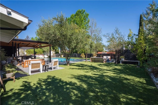 view of yard with a hot tub, a patio area, a fenced backyard, and an outdoor pool