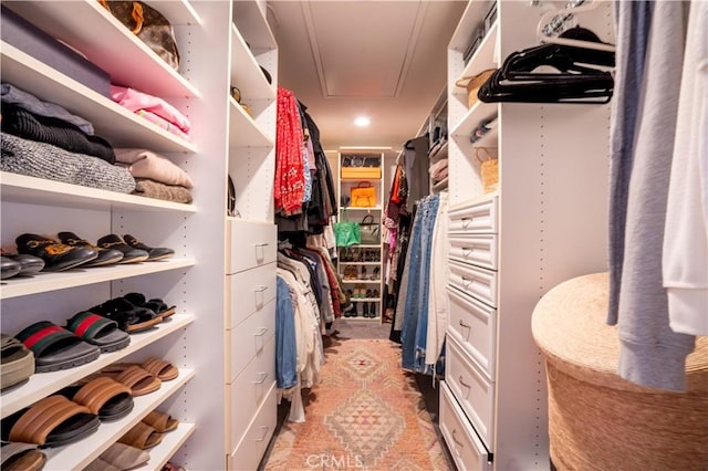 spacious closet featuring attic access