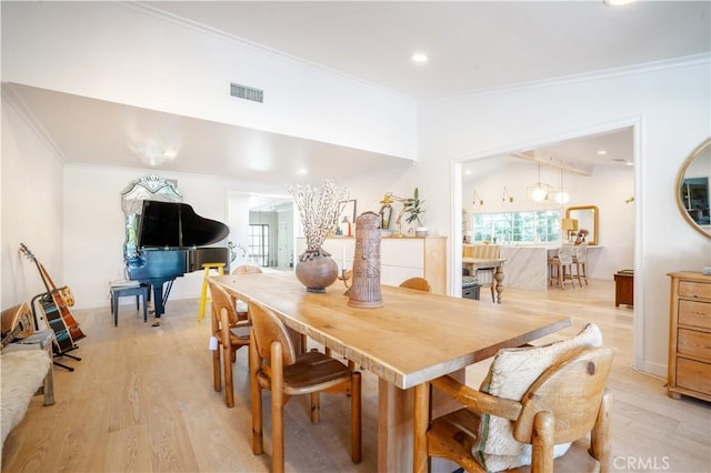 dining room featuring crown molding, lofted ceiling, recessed lighting, visible vents, and light wood-type flooring