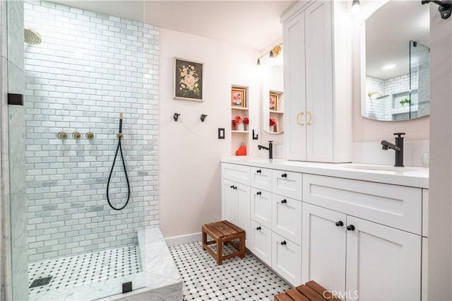 bathroom featuring double vanity, a walk in shower, and a sink