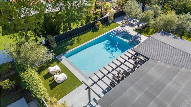 view of swimming pool featuring a fenced in pool, fence, a lawn, and a jacuzzi