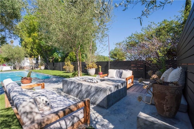 view of patio / terrace featuring an outdoor living space with a fire pit, a fenced backyard, and a fenced in pool