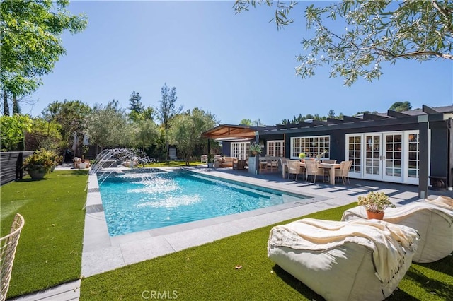 pool featuring french doors, a yard, and a patio