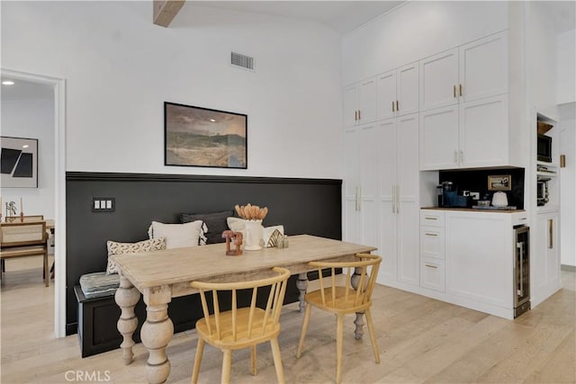 5910 Pat Ave, Woodland Hills, CA 91367 - dining area featuring breakfast area, beverage cooler, light wood-type flooring, a high ceiling, and bar area