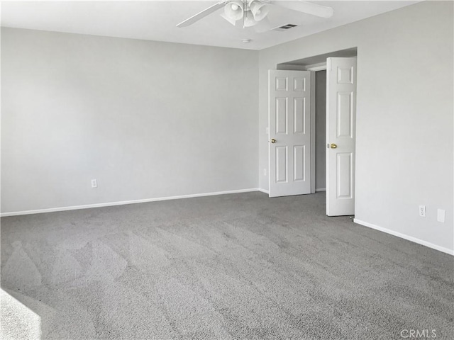 unfurnished room featuring carpet, visible vents, ceiling fan, and baseboards