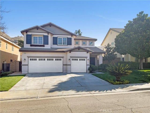 view of front of property with driveway, an attached garage, and stucco siding