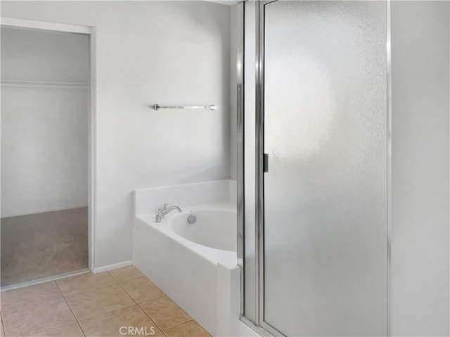 full bathroom with tile patterned floors, a garden tub, and a shower stall