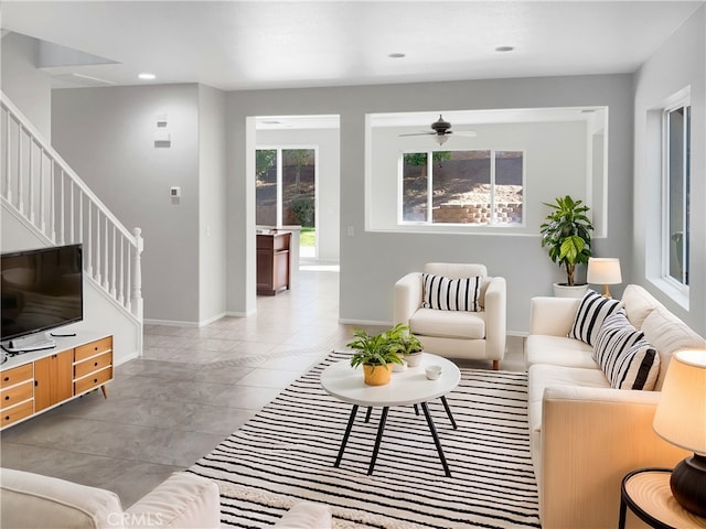 living area with baseboards, a ceiling fan, tile patterned flooring, stairs, and recessed lighting