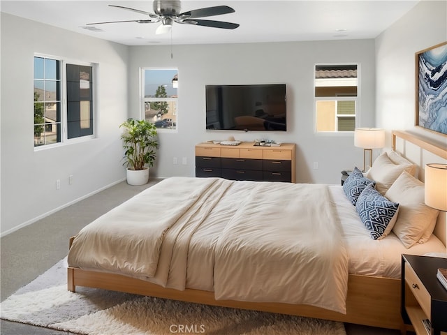 bedroom featuring a ceiling fan, carpet flooring, visible vents, and baseboards