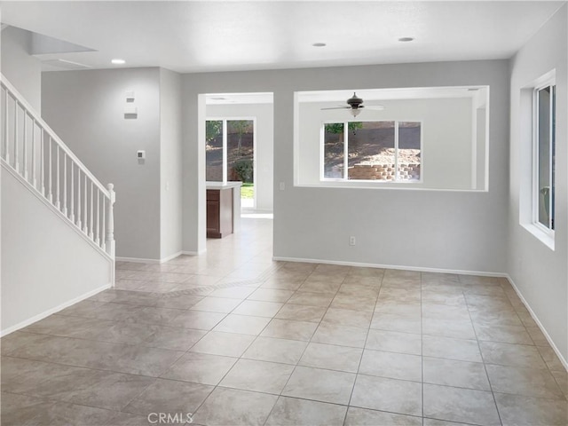 empty room with light tile patterned floors, baseboards, a ceiling fan, stairs, and recessed lighting