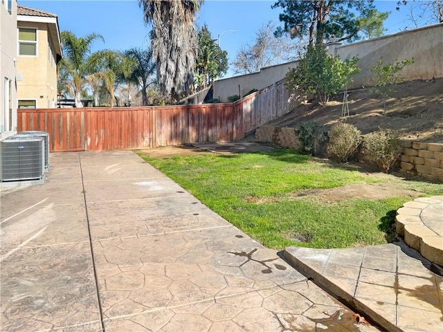 view of yard with central air condition unit, a patio area, and a fenced backyard