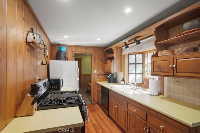 kitchen featuring black appliances, light countertops, open shelves, and a sink