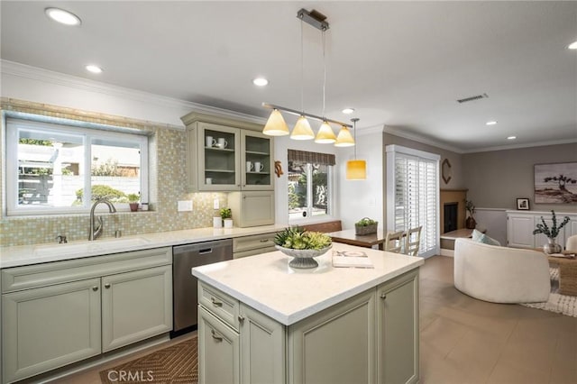 kitchen featuring pendant lighting, light countertops, dishwasher, and open floor plan