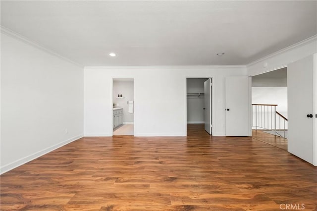 unfurnished bedroom with crown molding, baseboards, and dark wood-style flooring