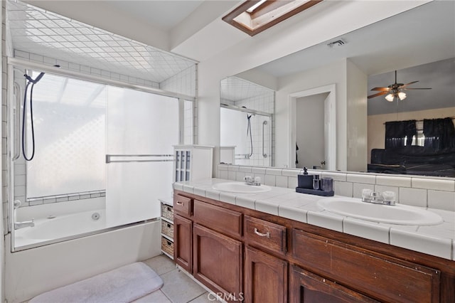 full bathroom featuring double vanity, shower / bath combination with glass door, visible vents, and a sink