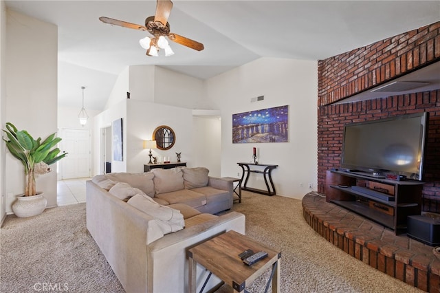 living area with high vaulted ceiling, visible vents, a ceiling fan, and light colored carpet