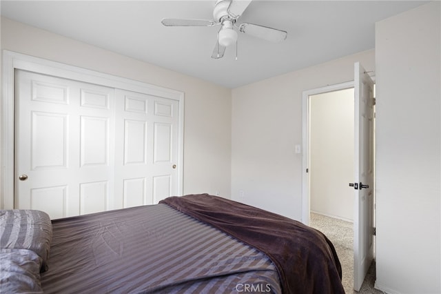 carpeted bedroom featuring a closet and ceiling fan