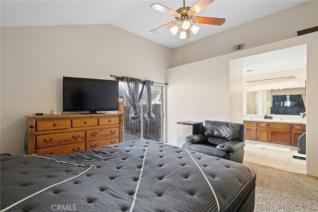 bedroom with ensuite bathroom, light tile patterned flooring, a ceiling fan, visible vents, and vaulted ceiling