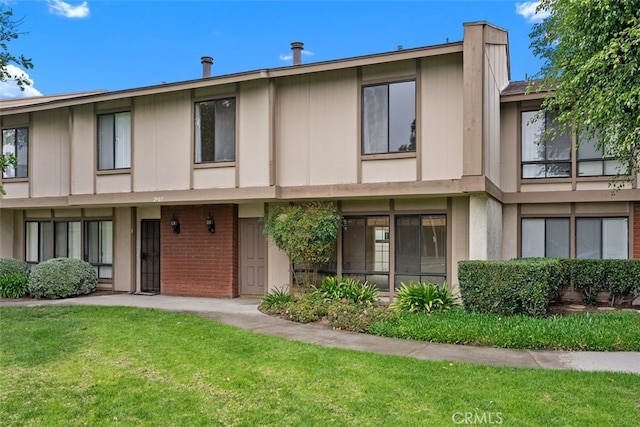 multi unit property with a chimney and a front lawn