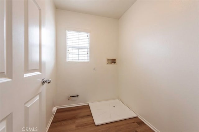 laundry room with laundry area, wood finished floors, hookup for a washing machine, and baseboards