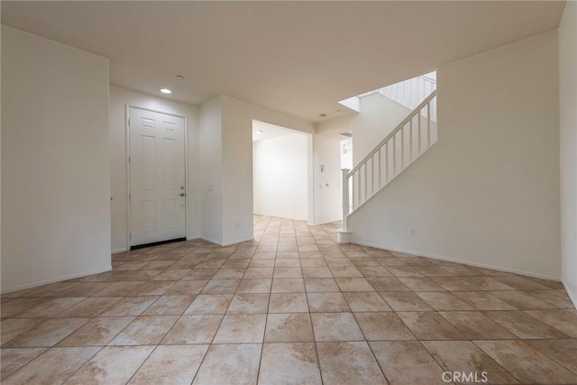 unfurnished room with stairs, light tile patterned floors, baseboards, and recessed lighting