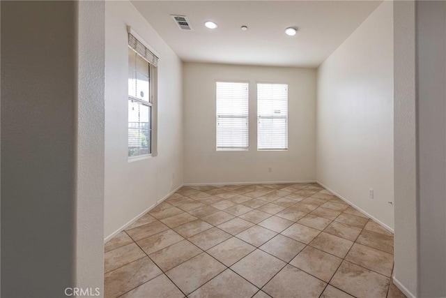 unfurnished room with visible vents and light tile patterned flooring