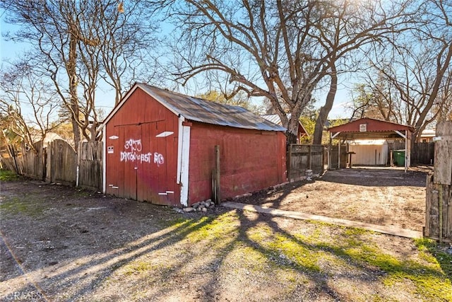 view of outbuilding featuring an outbuilding and fence