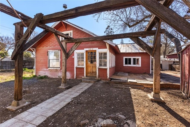 bungalow-style house featuring entry steps and fence