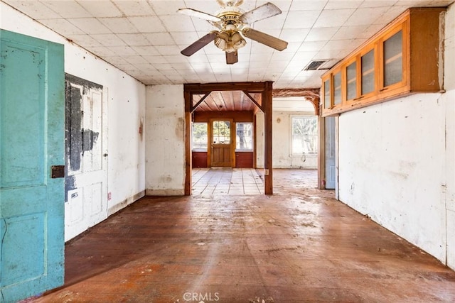 interior space with ceiling fan, wood-type flooring, and visible vents