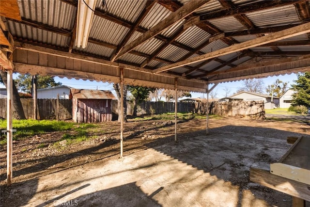 exterior space featuring a gazebo, a storage shed, a fenced backyard, and an outbuilding