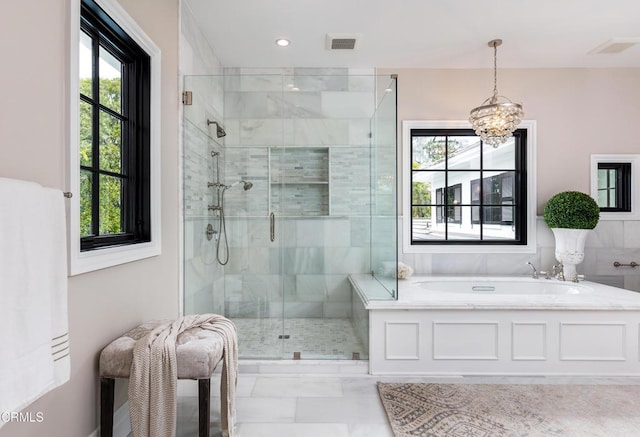 full bathroom featuring a stall shower, visible vents, a bath, and an inviting chandelier