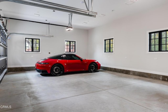 garage with baseboards and a garage door opener