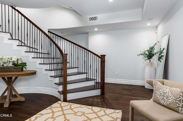 staircase with baseboards, visible vents, wood finished floors, and recessed lighting