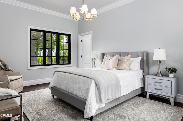 bedroom with baseboards, a chandelier, crown molding, and wood finished floors