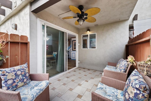 view of patio with a ceiling fan and fence