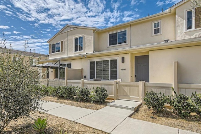 35107 Rangpur Ln, Fallbrook, CA 92028 - townhome / multi-family property with a gate, a fenced front yard, and stucco siding