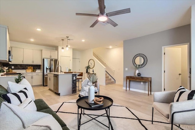 35107 Rangpur Ln, Fallbrook, CA 92028 - living area featuring light wood-style floors, stairway, ceiling fan, recessed lighting, and baseboards