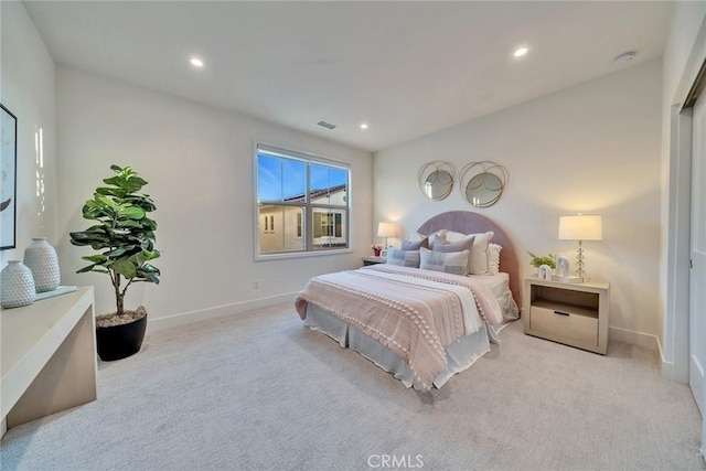 bedroom with recessed lighting, light carpet, visible vents, and baseboards