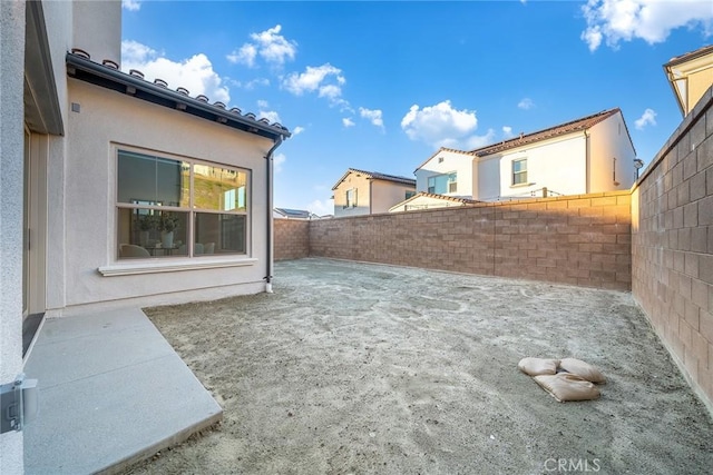 view of yard with a fenced backyard and a patio