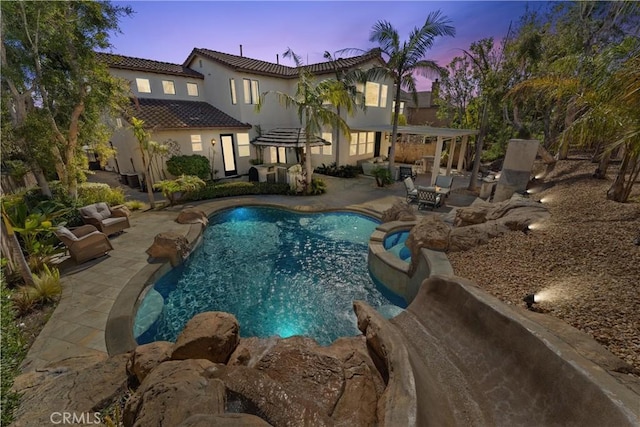 view of swimming pool featuring a patio and a pool with connected hot tub