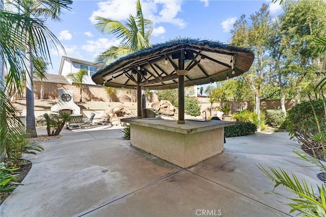 view of patio / terrace with a fenced backyard and an outdoor kitchen