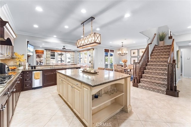 kitchen featuring light stone countertops, cream cabinetry, a sink, and light tile patterned floors